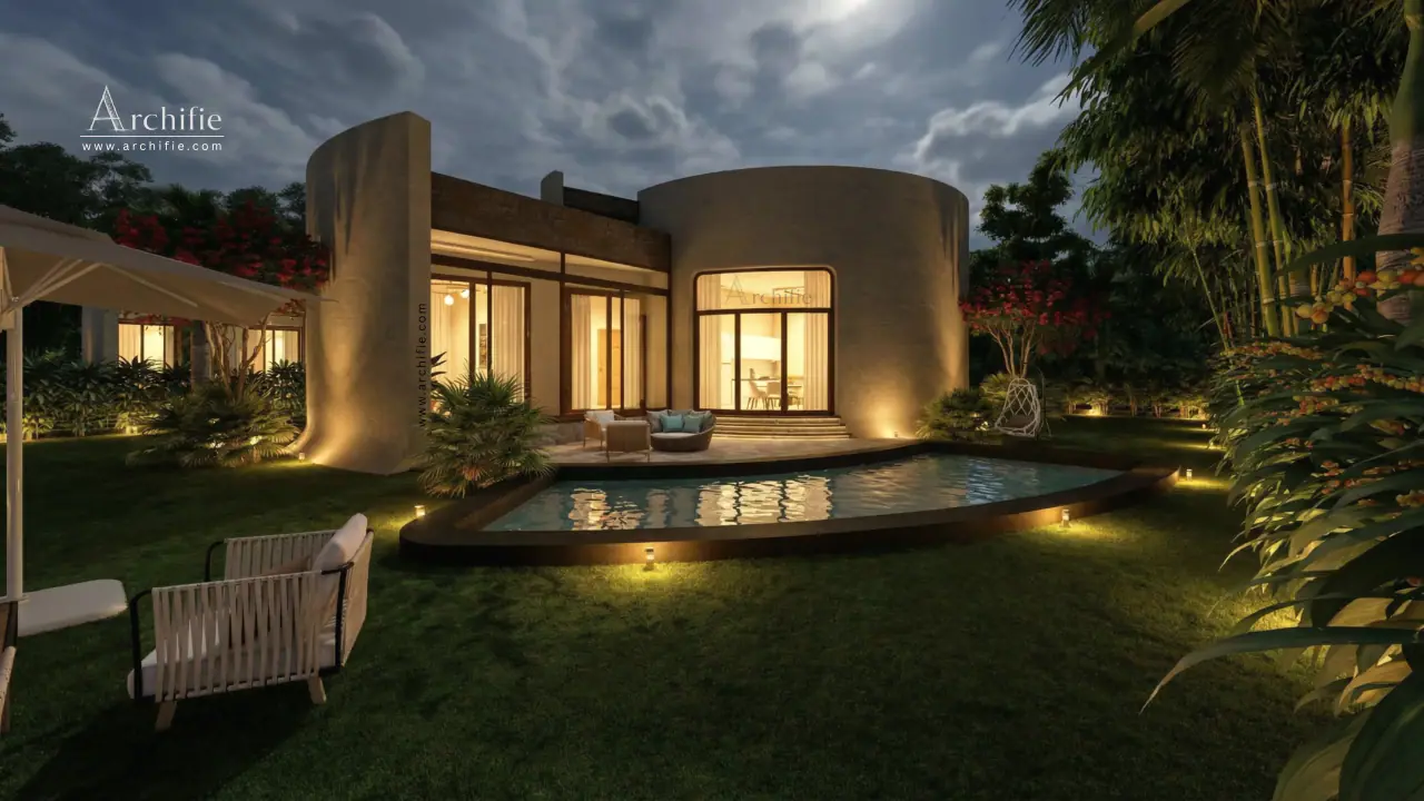 A single-storey curved residence at night, its glass doors opening onto a lawn-side pool